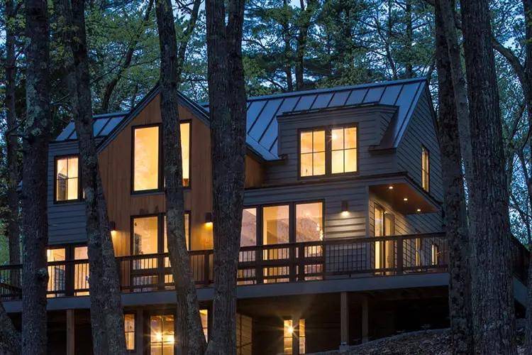 Lit windows through the trees – Lake House, Windham, Maine
