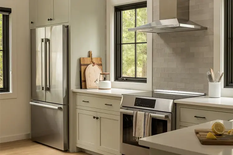 White kitchen with range hood and lake views – Lake House project, Windham, Maine
