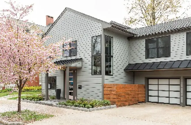 Renovated gray-sided home with modern garage door in Portland, Maine