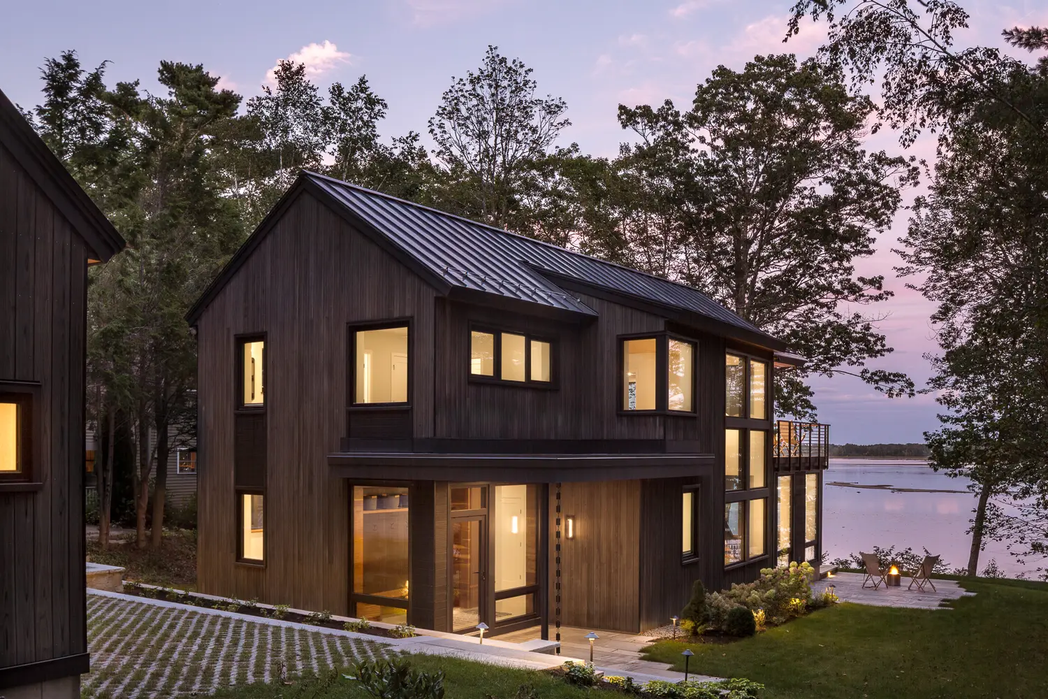Gable end of a modern coastal home facing the water at dusk – Whites Cove project, Yarmouth, Maine, near Cumberland