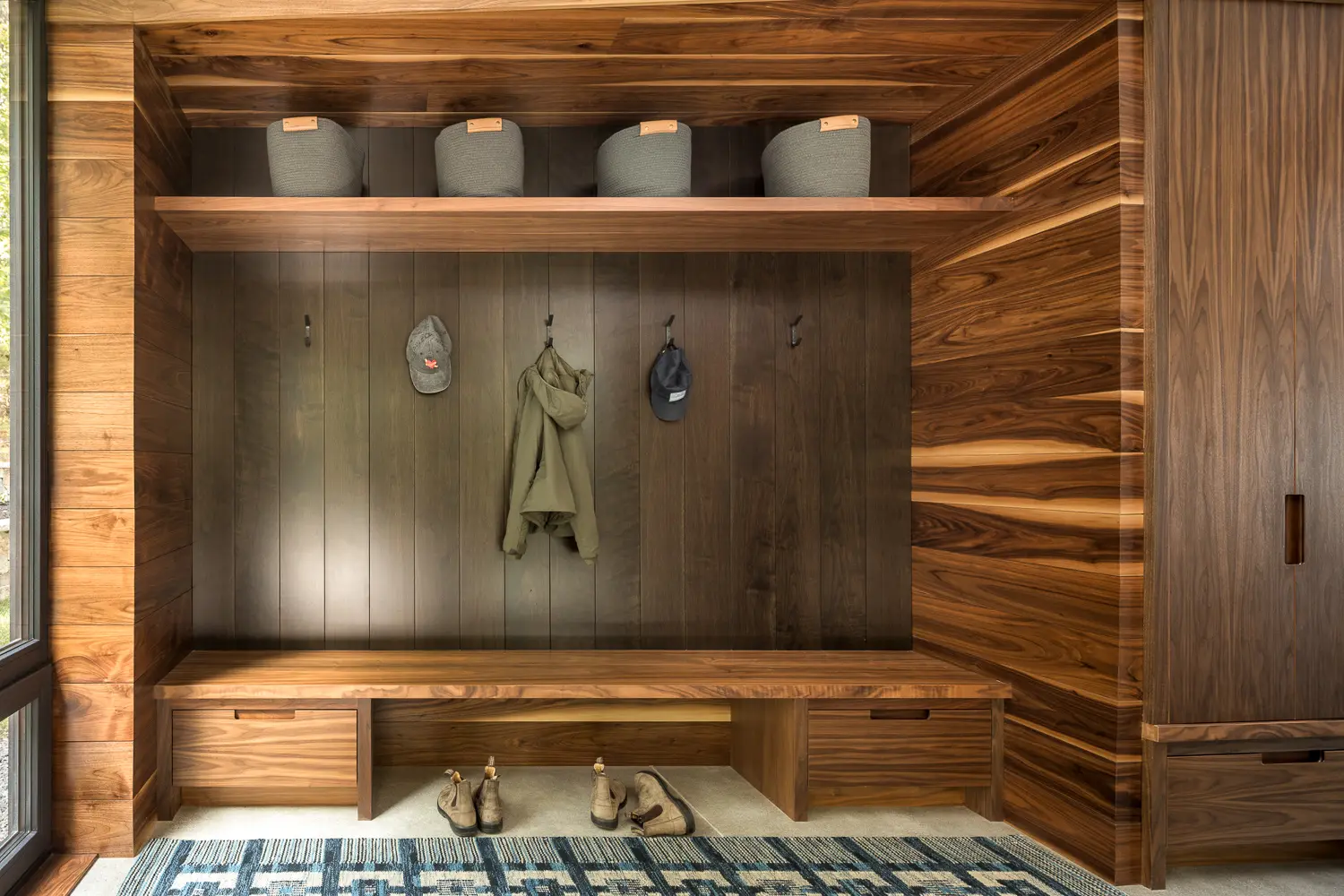 Walnut-lined mudroom with bench – Whites Cove net-zero home, Yarmouth, Maine